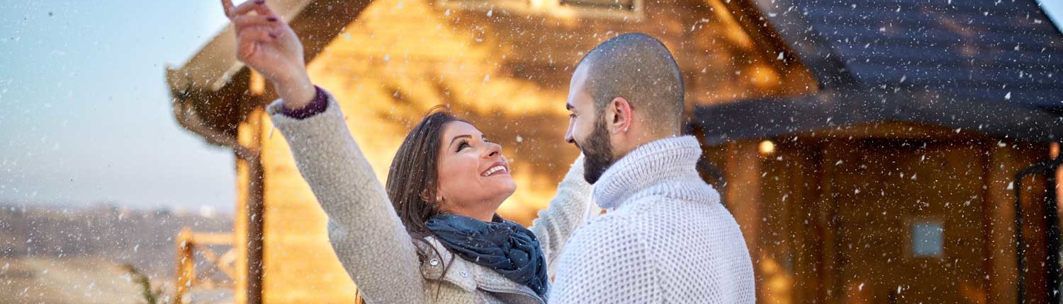 Couple in front of new home